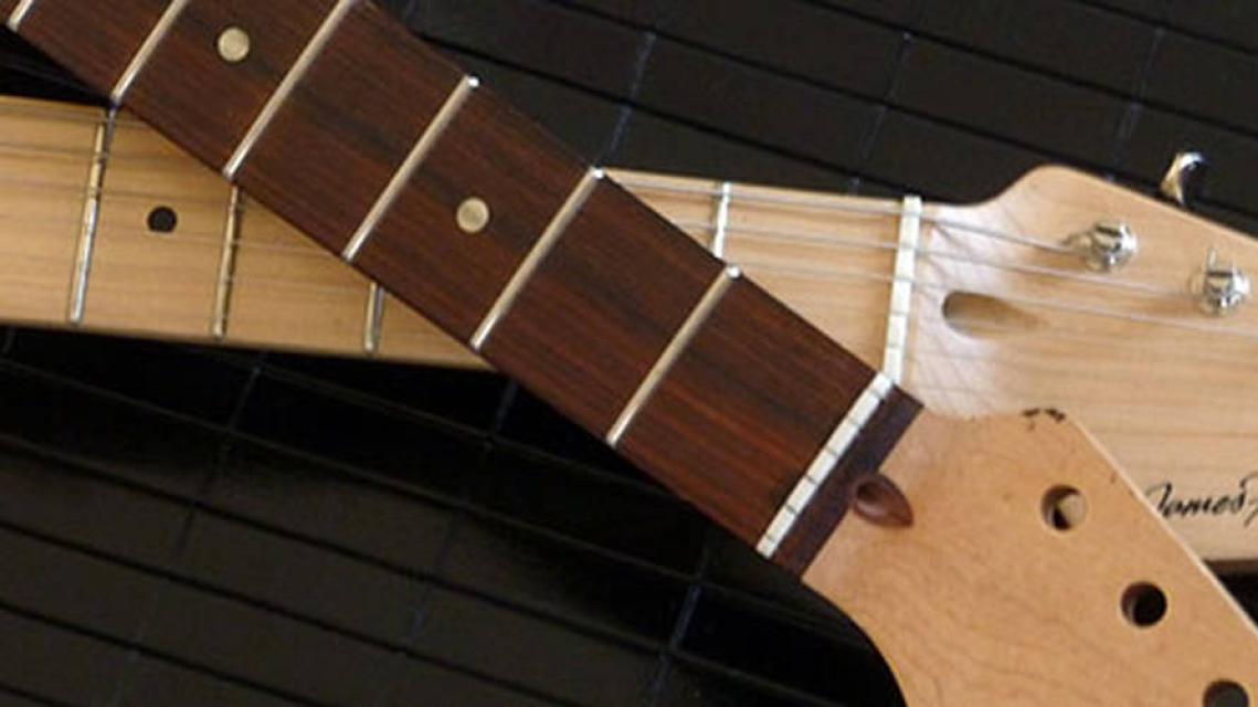 two guitar necks with maple and rosewood fingerboards