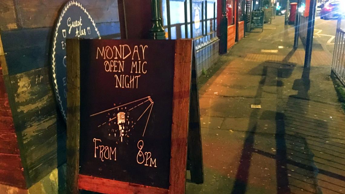 Sandwich Board outside pub announces 'Open Mic Night'